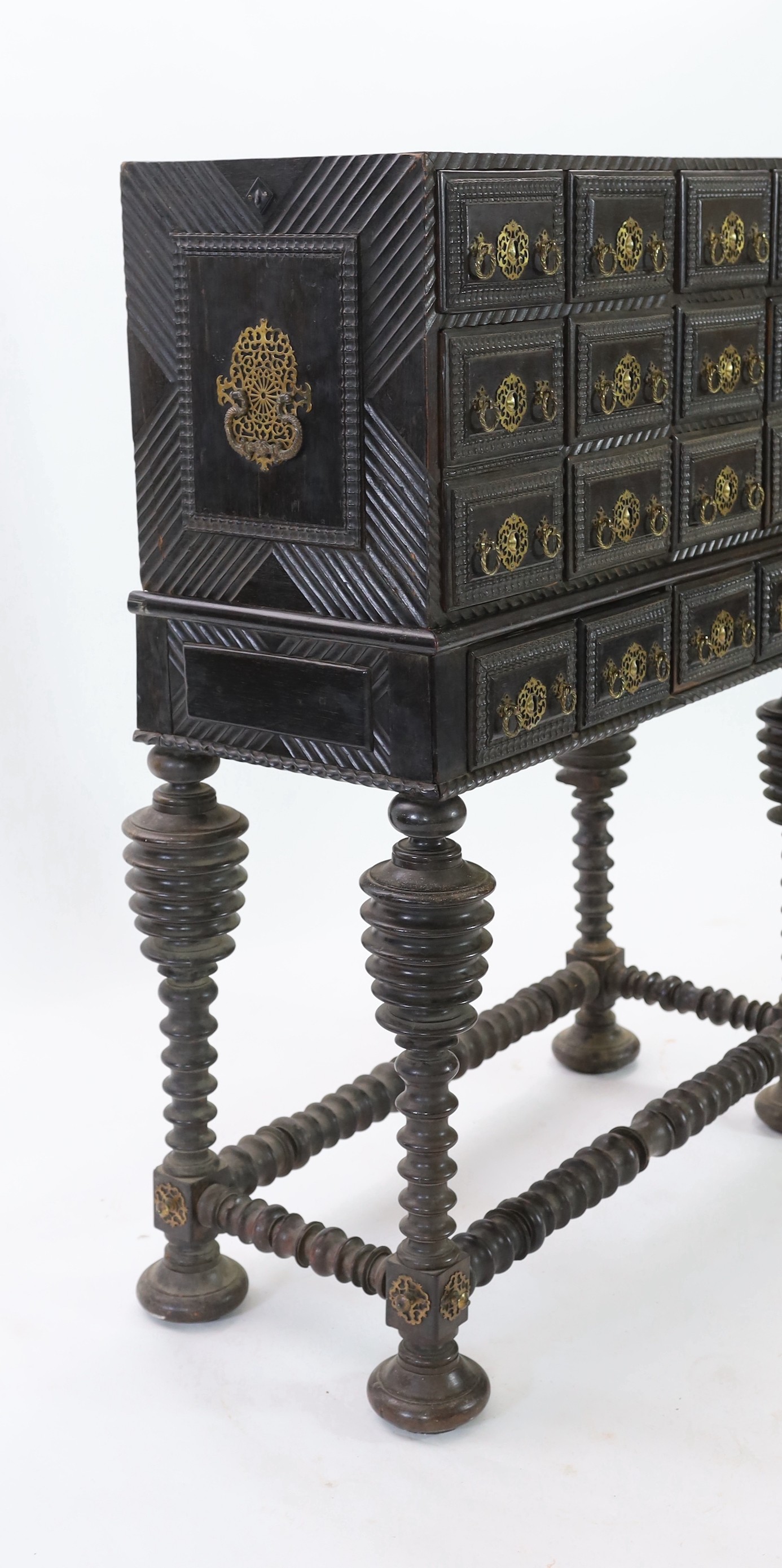 A 17th century Portuguese brass mounted ebonised rosewood Contador on stand Width 105cm. Height 136cm. Depth 50cm.